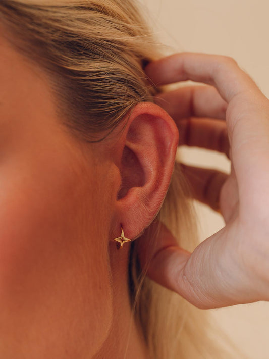 gold single star huggies on close up of ear