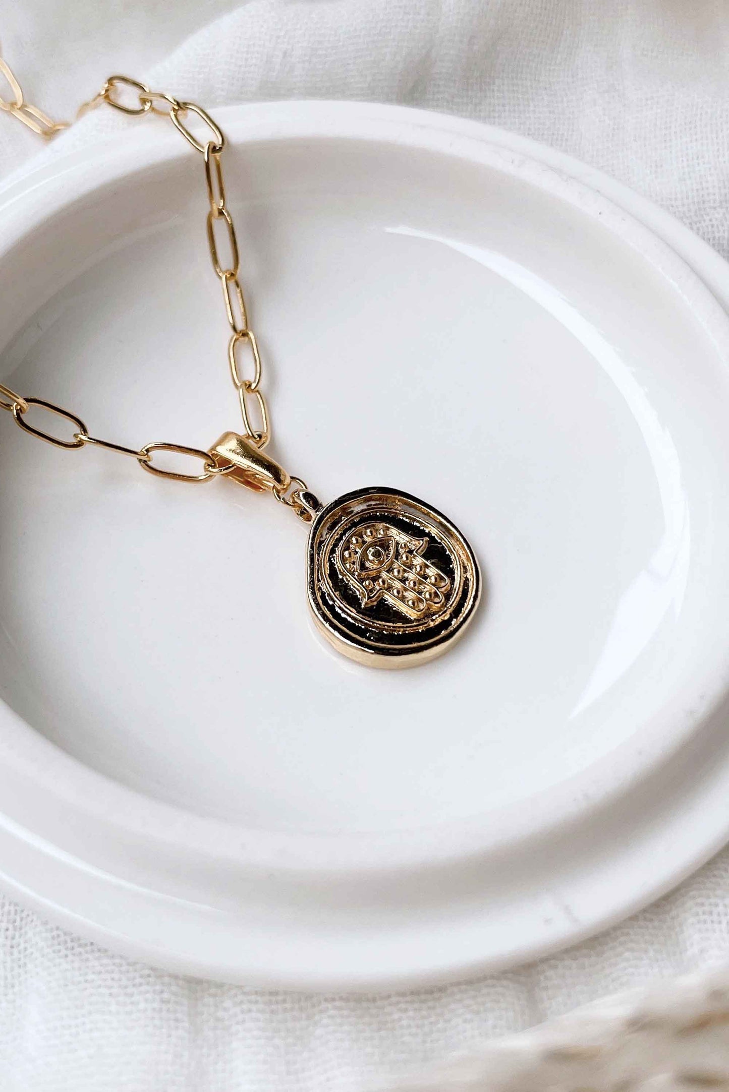 Hamsa-Hand-Talisman-Spiritual-Pendant-Necklace-on-dish