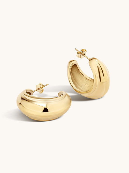 Gold statement hoop earrings on a white background