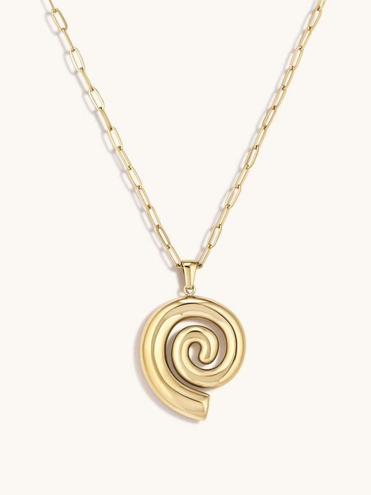 Gold spiral pendant necklace on a white background