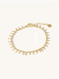 Gold bracelet with textural bars on a white background