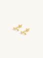 Pair of gold triple star crawler stud earrings on a white background