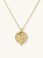 A gold chain necklace featuring a circular pendant with agoddess artemis figure, displayed against a clean off-white background.