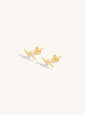 Gold lightning stud earrings on a white background